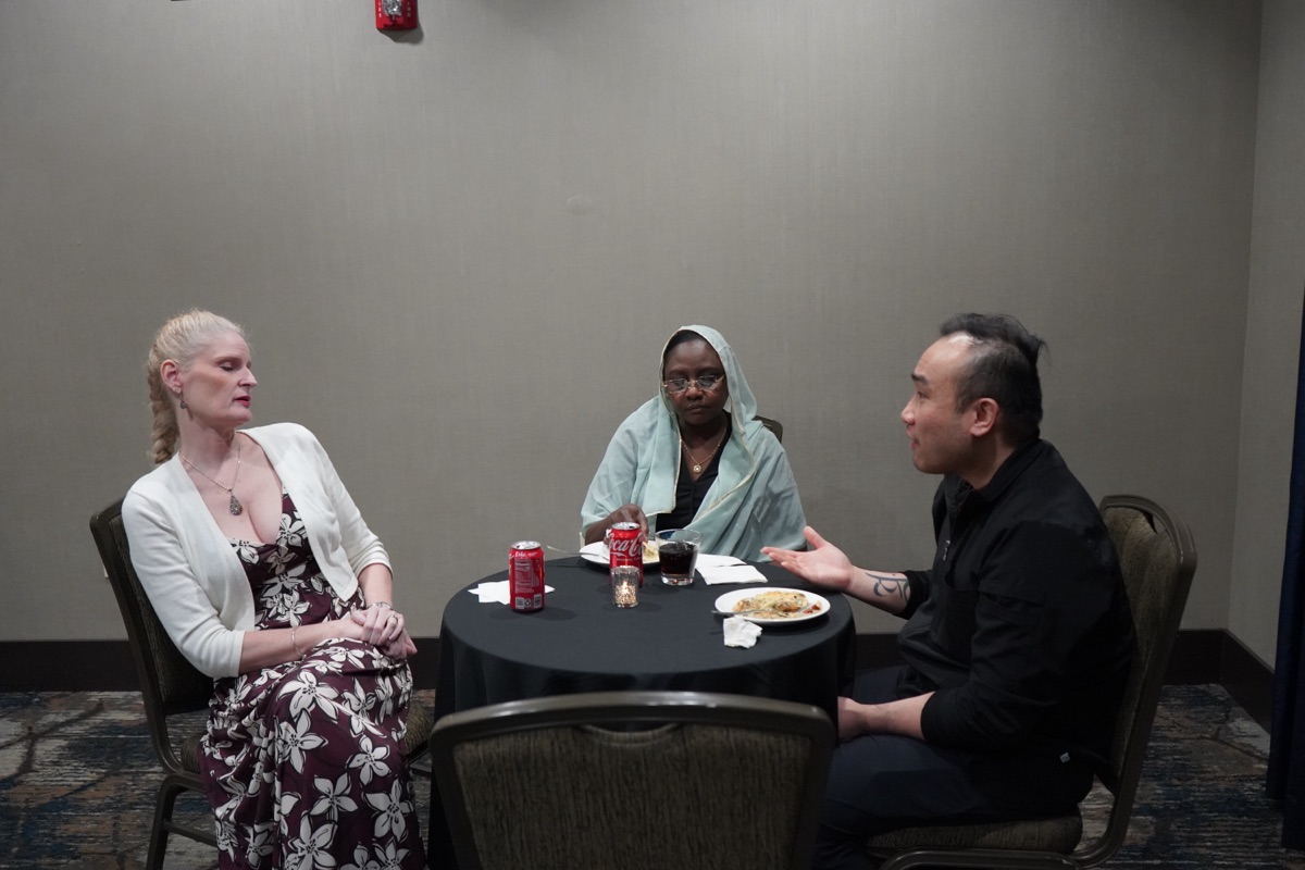 Three delegates in conversation
